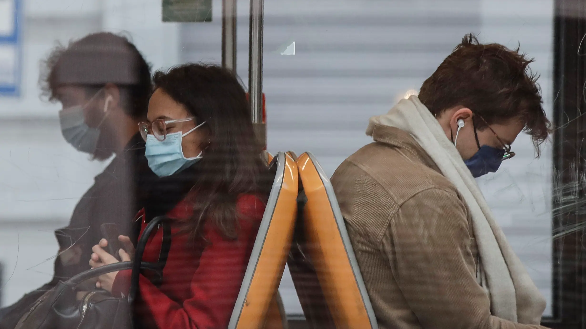 People wearing face masks to prevent the spread of COVID-19 sit on a bus, in Milan, Italy, Wednesday, Oct. 14, 2020. Italian Premier Giuseppe Conte says the aim of Italy's new anti-virus restrictions limiting nightlife and socializing is to head off another generalized lockdown. (AP Photo/Luca Bruno)
